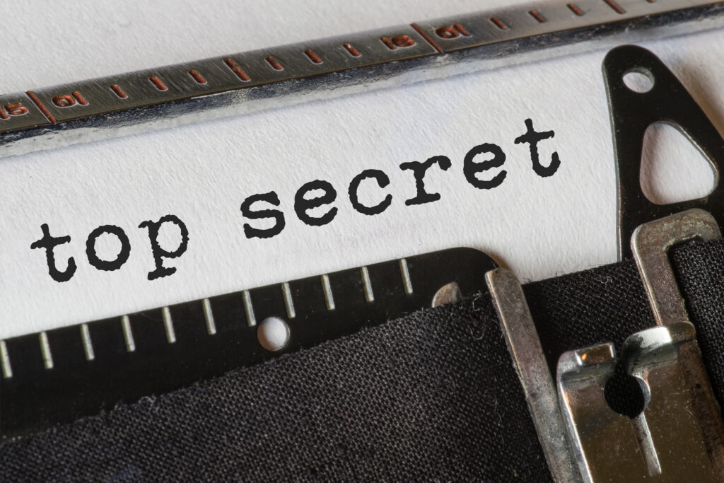 Typewriter with "Top Secret" text on paper.