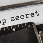 Typewriter with "Top Secret" text on paper.